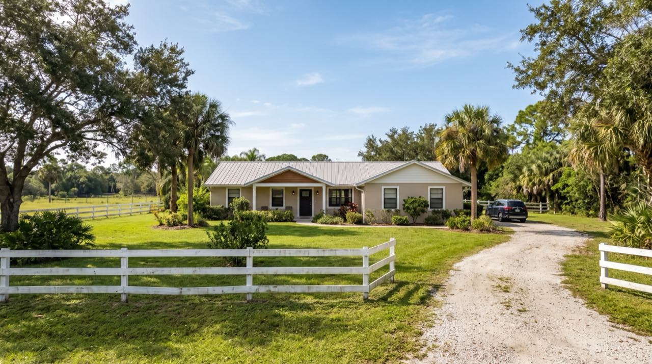 Private driveway to a ranch-style estate on open acreage in Southwest Ranches at sunset